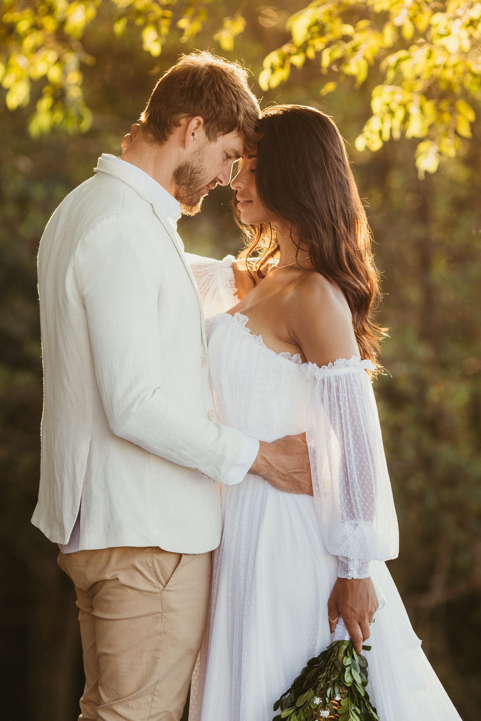 Couple embracing outdoors in warm natural light