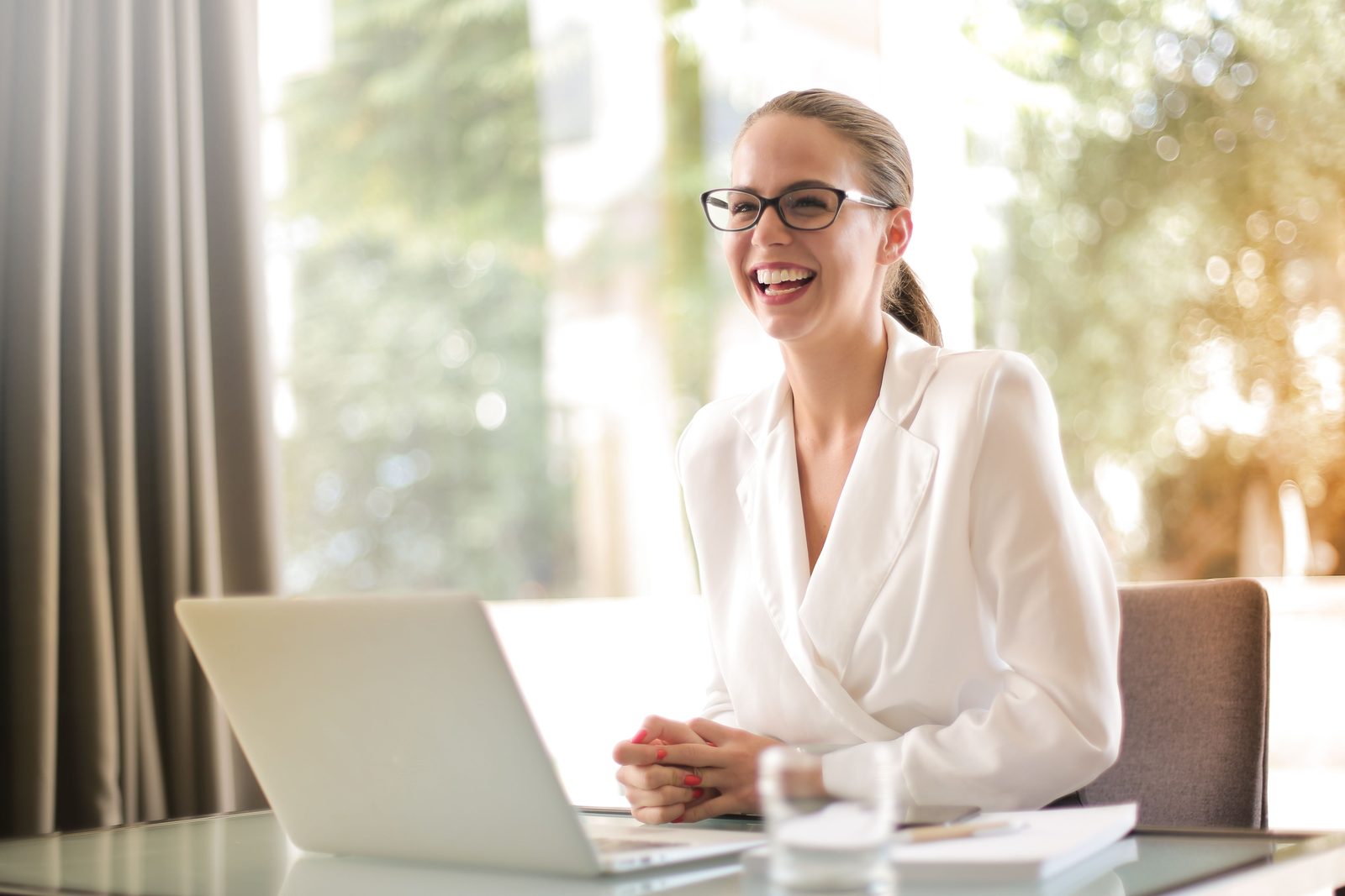 Professional woman working at a laptop in a bright interior