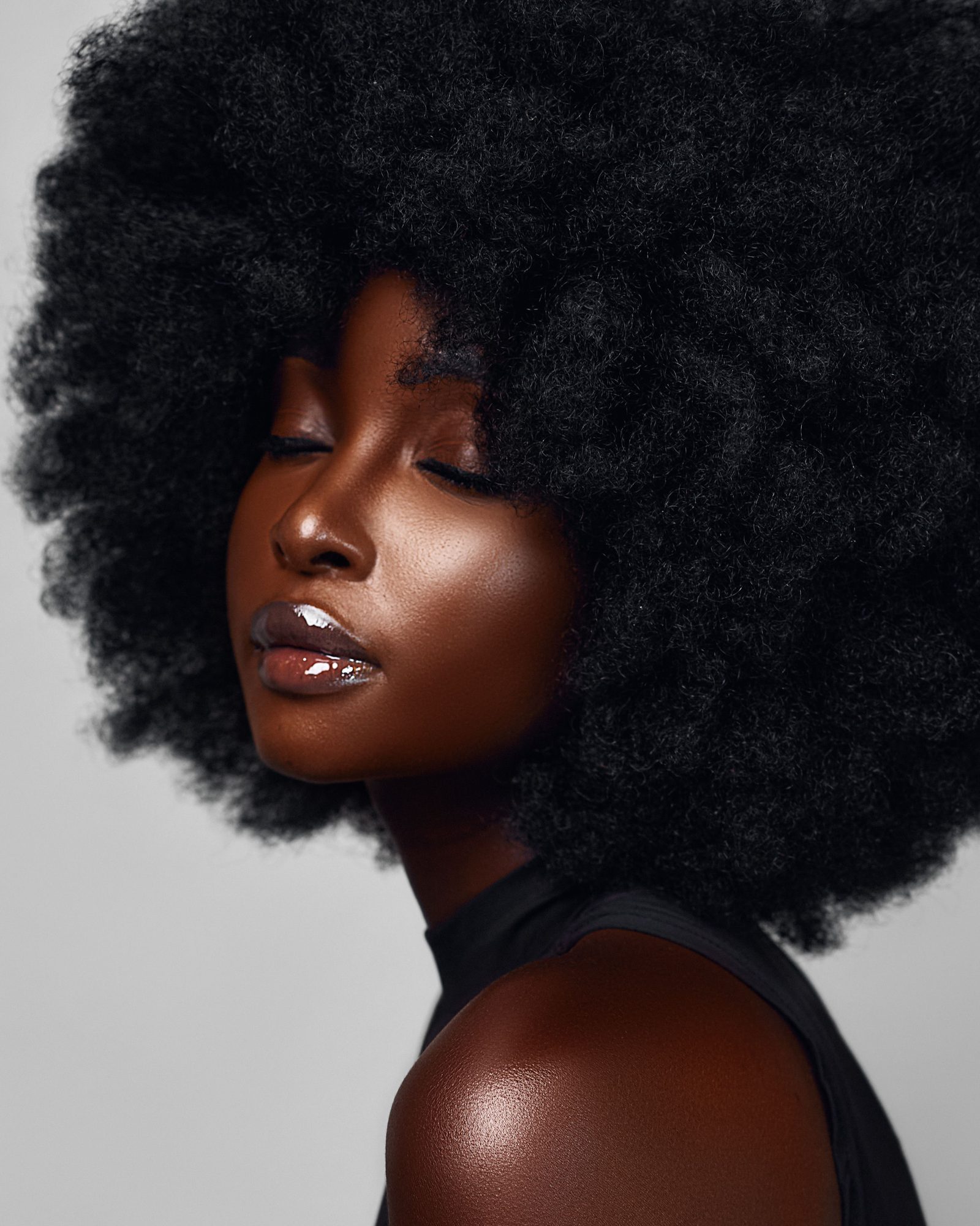 Editorial portrait of a woman photographed against a neutral studio background